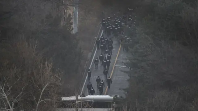 Aerial shot of investigators walking in Yoon's presidential compound