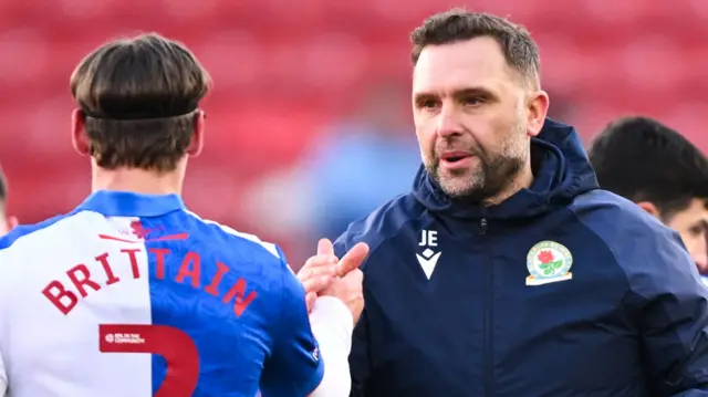 Blackburn head coach John Eustace shakes hands with Callum Brittain