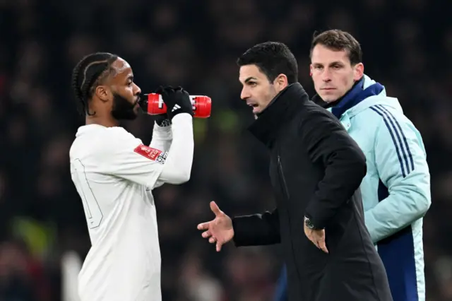 Arteta speaks to Raheem Sterling during FA Cup third round tie against Man Utd