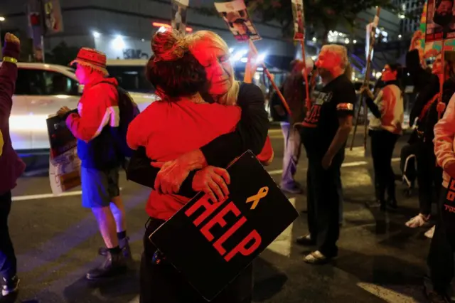 Supporters of Israeli hostages, who were kidnapped during the deadly October 7 2023 attack by Hamas, hug each other, as they attend a protest to demand a deal to bring every hostage home at once, amid Gaza ceasefire negotiations