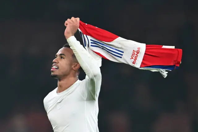 Gabriel waves his Arsenal top above his head