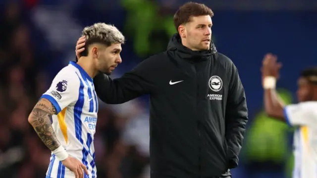 Brighton & Hove Albion manager Fabian Hurzeler with a dejected Julio Enciso