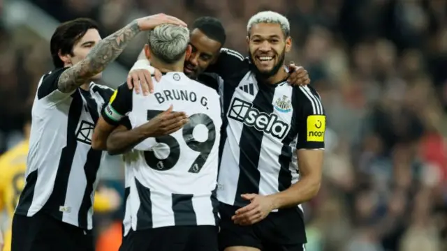 Newcastle players celebrate after scoring against Wolves