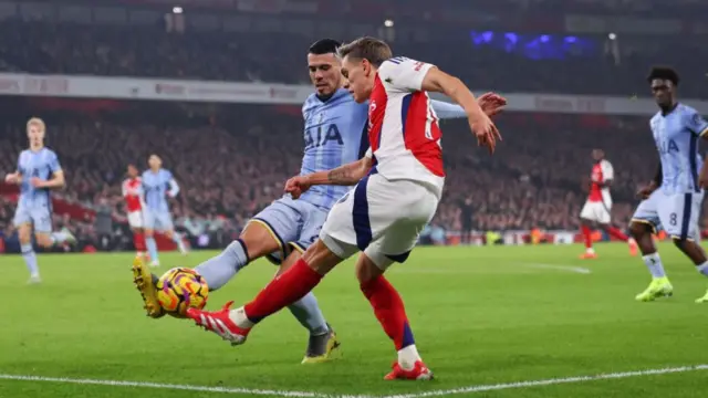 Leandro Trossard and Pedro Porro battle for the ball