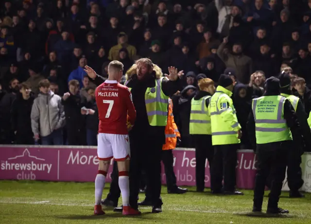 Wrexham's James McClean is engaged by stewards