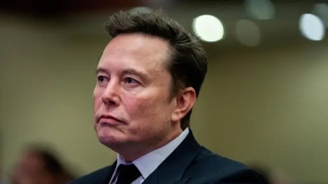 Tesla CEO and X owner Elon Musk listens as US President-elect Donald Trump speaks during a meeting with House Republicans at the Hyatt Regency hotel in Washington, DC