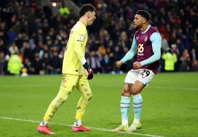 James Trafford of Burnley celebrates with team-mate Josh Laurent after saving a penalty from Wilson Isidor of Sunderland