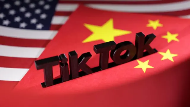 TikTok logo is placed on the U.S. and Chinese flags in this illustration taken, April 25, 2024.