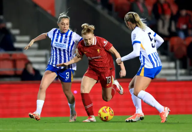 Ceri Holland of Liverpool controls the ball under pressure from Poppy Pattinson and Guro Bergsvand of Brighton