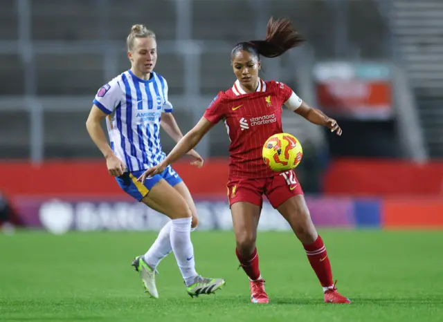 Taylor Hinds of Liverpool controls the ball whilst under pressure from Rachel Mclauchlan of Brighton