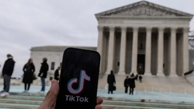 Description The TikTok logo is displayed on a mobile phone next to the U.S. Supreme Court, in this picture illustration taken January 17, 2025.