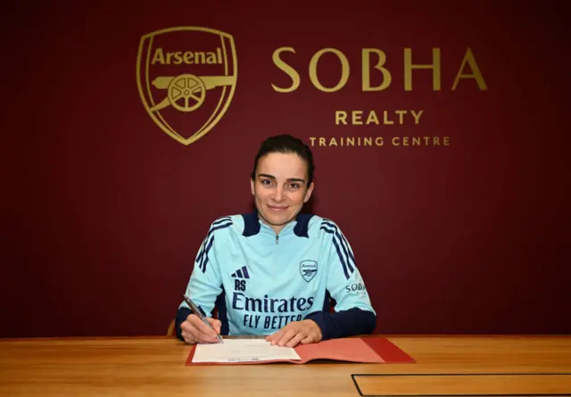 Arsenal manager Renee Slegers signing a contract