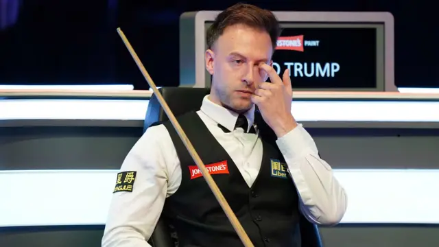 Judd Trump sits in his chair