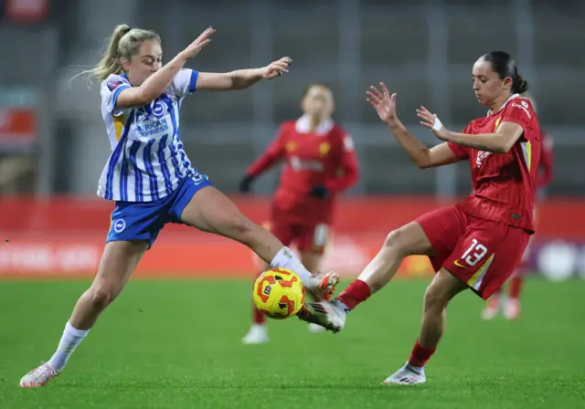 Mia Enderby of Liverpool is challenged by Poppy Pattinson of Brighton & Hove Albion