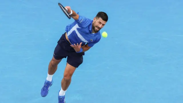 Novak Djokovic serves