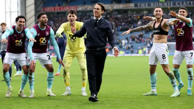 Burnley's players and boss Scott Parker celebrate with their fans after beating Blackburn