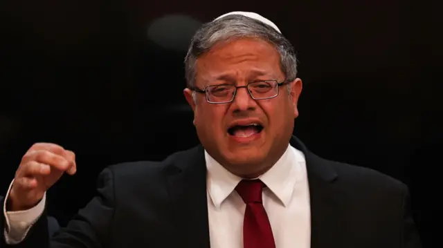 National Security Minister Itamar Ben Gvir is seen wearing a kippah and raising his right hand