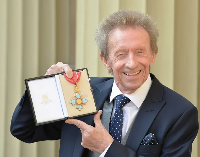 Denis Law with his CBE in 2016