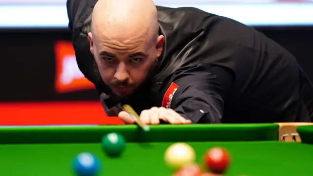 Luca Brecel plays a shot at the Masters