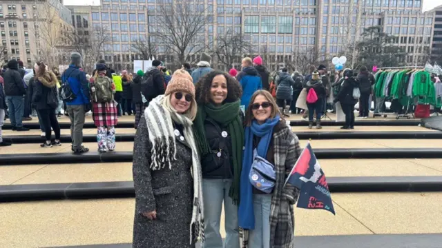 Three women smile