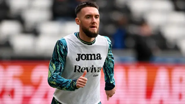 Swansea midfielder Matt Grimes warms up