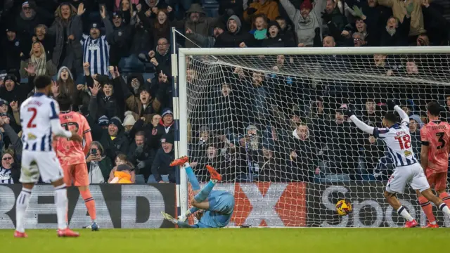 Stoke keeper Viktor Johansson can't keep Grady Diangana's effort