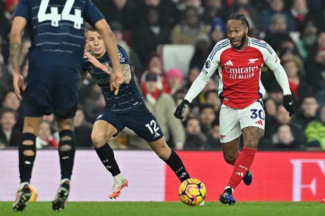 Raheem Sterling (R) runs with the ball