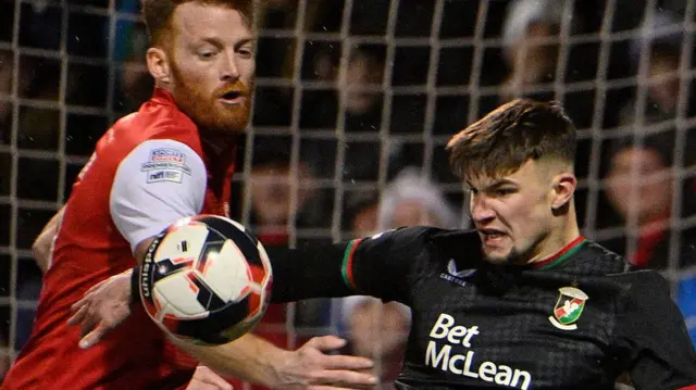 Larne defender Cian Bolger challenges David Fisher in last year's County Antrim Shield final