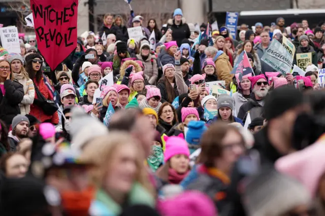 A crowd of mostly woman marching