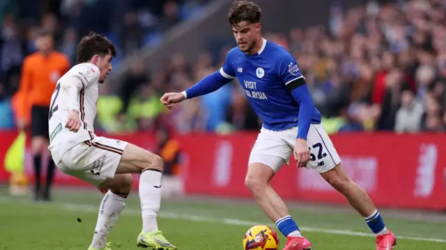 Cardiff wingers Ollie Tanner takes on Swansea's Josh Key