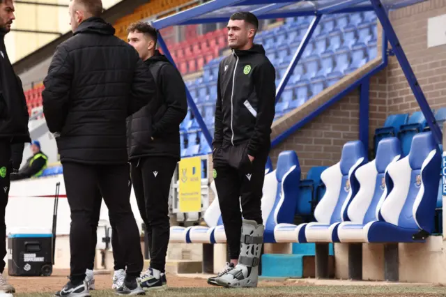 Lennon Miller looks on with his foot in a cast