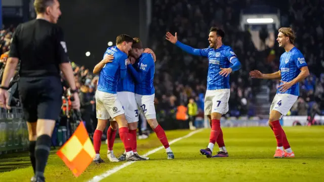 Jubilant Portsmouth players celebrate with goalscorer Matt Ritchie