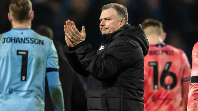 Stoke boss Mark Robins claps the fans after the draw at West Brom