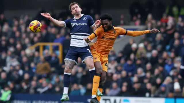 Hull's Abu Kamara beats Millwall's Joe Bryan to a header