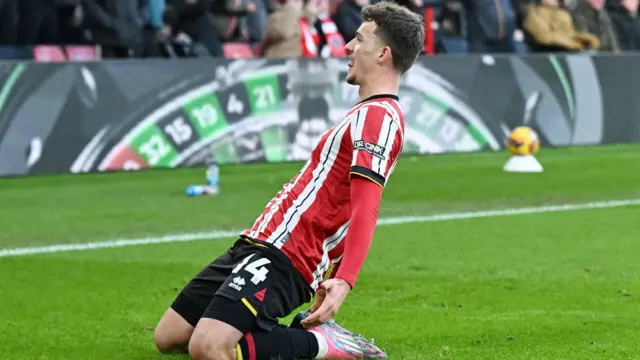 Sheffield United's Harrison Burrows slides on his knees after scoring against Norwich