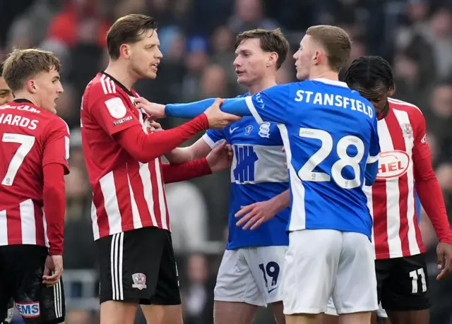 Birmingham and Exeter players confront each other