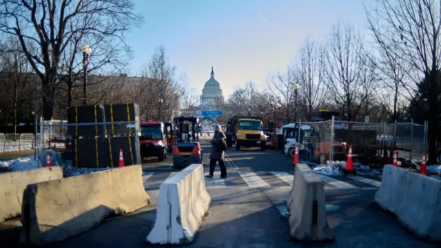 Security trucks seen in the foreground of the US Capitol