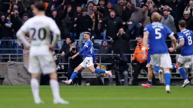 Callum Robinson celebrates in front of the Cardiff fans