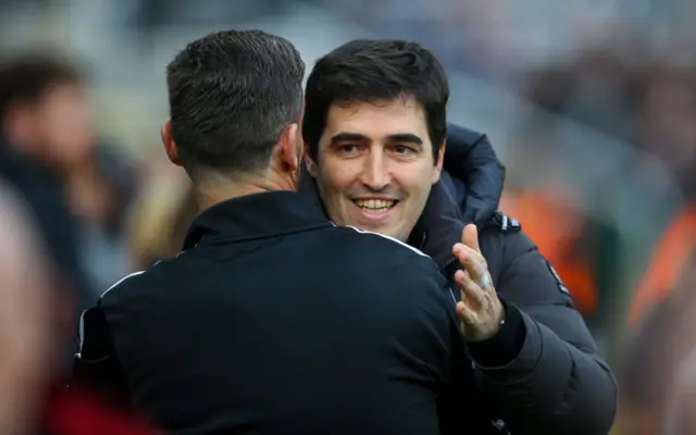 Andoni Iraola hugs Newcastle United assistant manager Jason Tindall.