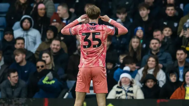 Nathan Lowe cups his ears to the West Brom fans