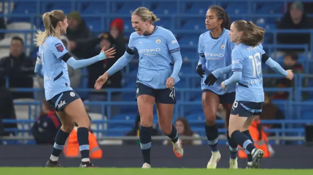 Rebecca Knaak of Manchester City celebrates scoring her team's second goal with Laia Aleixandri, Mary Fowler and Jess Park during the Barclays Women's Super League match between Manchester City and Manchester United