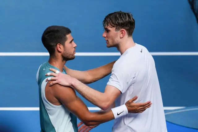 Carlos Alcaraz (L) of Spain greets Jack Draper of Great Britain