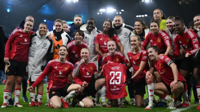 Anna Sandberg of Manchester United holds a shirt dedicated to teammate Geyse Da Silva Ferreira with teammates as they celebrate their victory after the Barclays Women's Super League match between Manchester City and Manchester United at Etihad Stadium