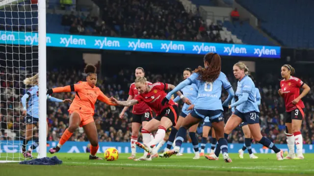 Leah Galton of Manchester United scores her team's second goal past Khiara Keating of Manchester City during the Barclays Women's Super League match between Manchester City and Manchester United