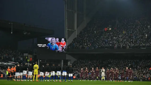 Players observe a minute's applause in honour of former Manchester United striker Denis Law.