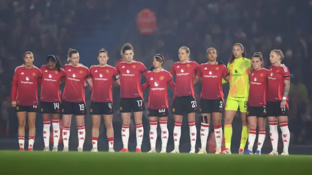 Players of Manchester United stand for a minute's silence in remembrance of Tony Brook and Denis Law prior to the Barclays Women's Super League match between Manchester City and Manchester United