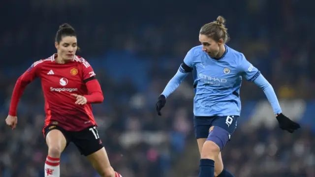 Vivianne Miedema of Manchester City makes a pass whilst under pressure from Dominique Janssen of Manchester United during the Barclays Women's Super League match between Manchester City and Manchester United