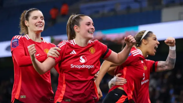 Ella Toone of Manchester United celebrates after scoring their side's fourth goal to complete their hat-trick during the Barclays Women's Super League match between Manchester City and Manchester United at Etihad Stadium