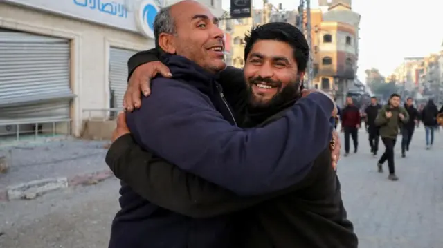 Two men hugging each other and smiling in Gaza city on Sunday morning 19 Jan