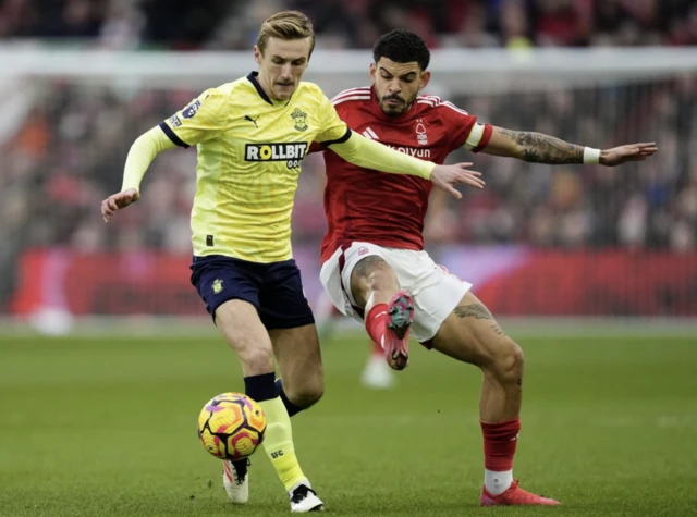 Southampton's Flynn Downes and Nottingham Forest's Morgan Gibbs-White (right) battle for the ball